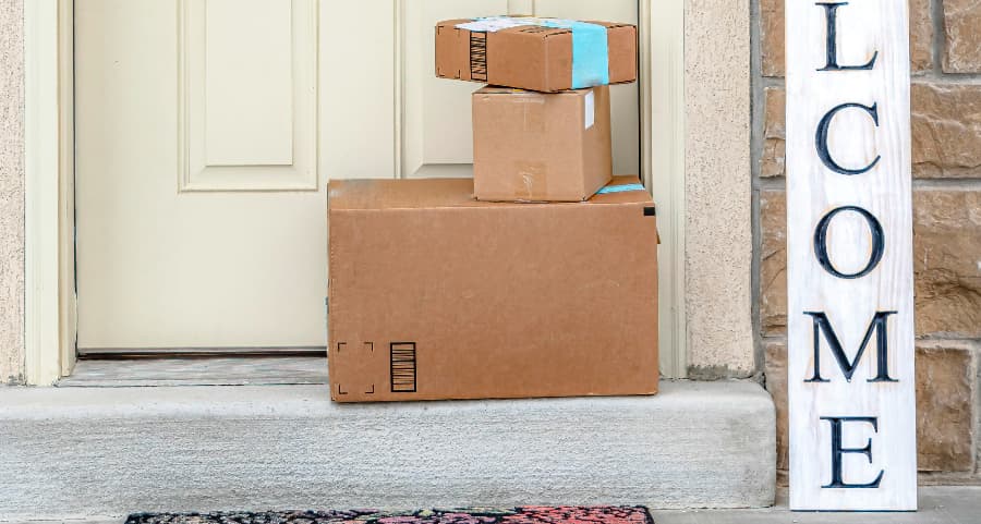 Boxes by the door of a residence with a welcome sign in Blacksburg